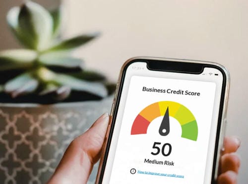 A smartphone displaying a business credit score of 50, categorized as medium risk.
