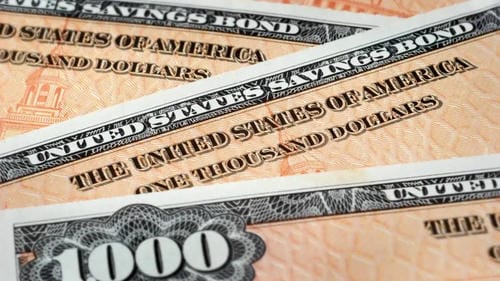 A close-up of United States Savings Bonds, highlighting the text and design of these financial securities.