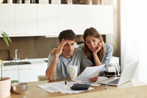 The first image shows a couple looking concerned while reviewing bills, which is a common starting point for many debt journeys. This stress often leads people to set clear financial goals, like the "Pay Off Debt" goal written in the notebook.